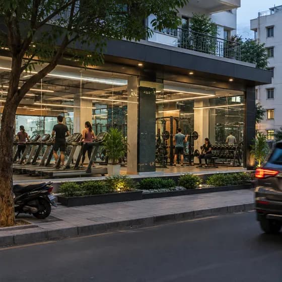 A ground-floor gym with glass windows and people working out inside